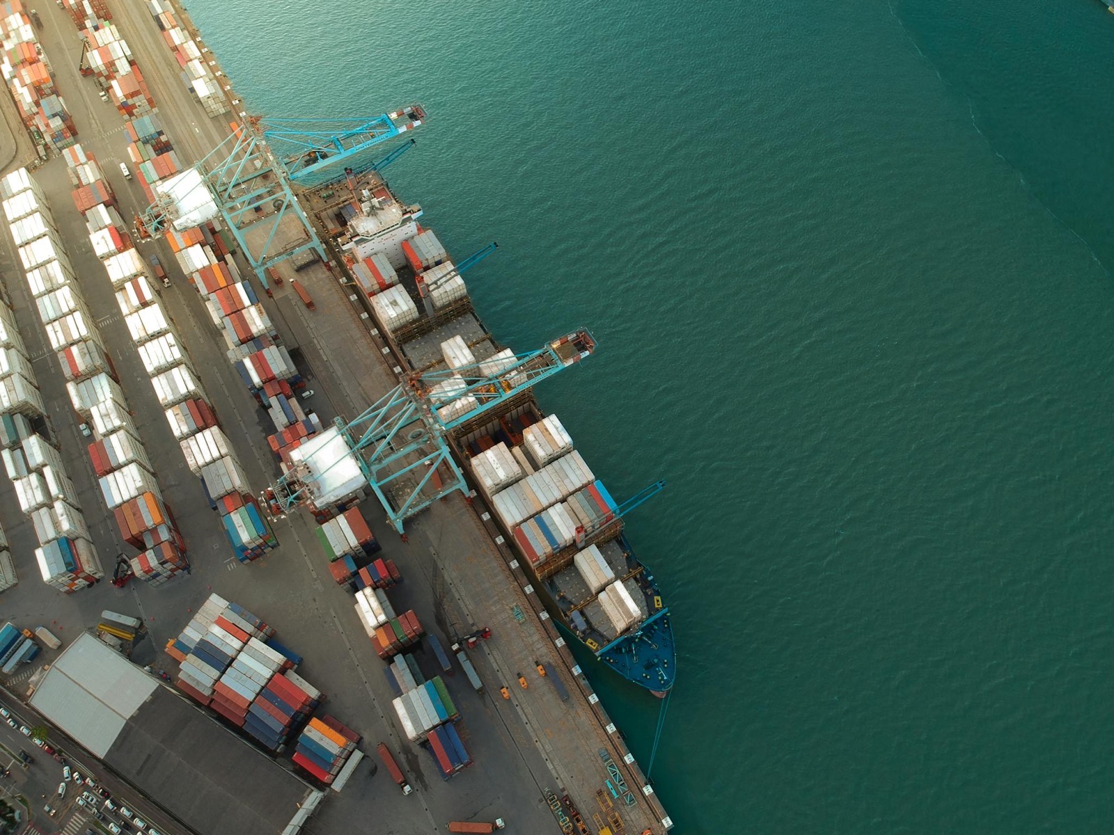 Aerial view of a container terminal with ships loading at the quay
