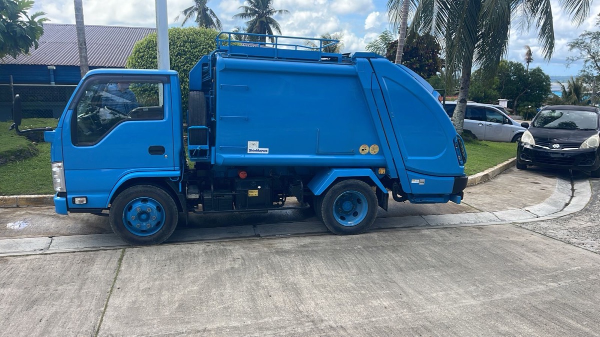 A garbage compactor truck delivered to a Pacific island nation